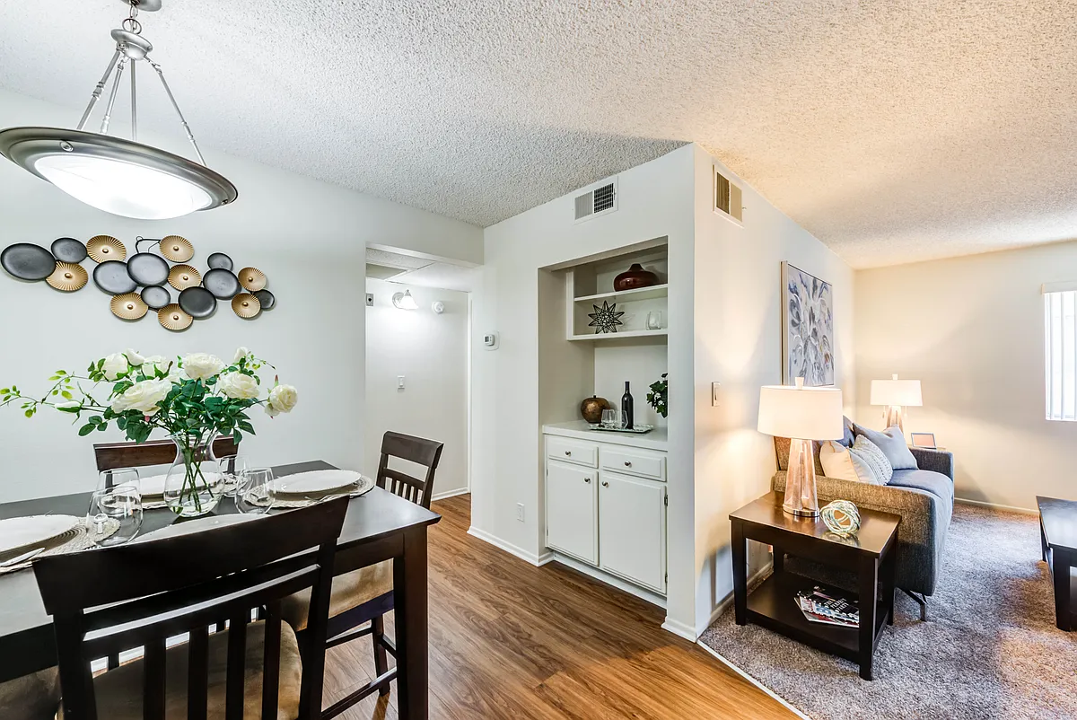 Spacious dining room with plank flooring at the Plaza Apartments - The Plaza