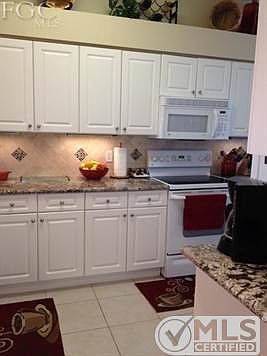 Gorgeous updated kitchen with newer granite, tile backsplash, under and over cabinet lighting