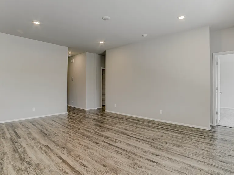 Straight ahead is the hallway to bedrooms 2, 3, 4, and a full bathroom. To the right is the entrance to the master bedroom.