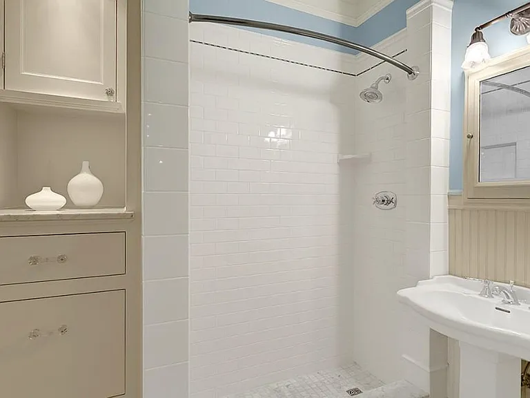 Updated bathroom with tiled shower and ample storage space