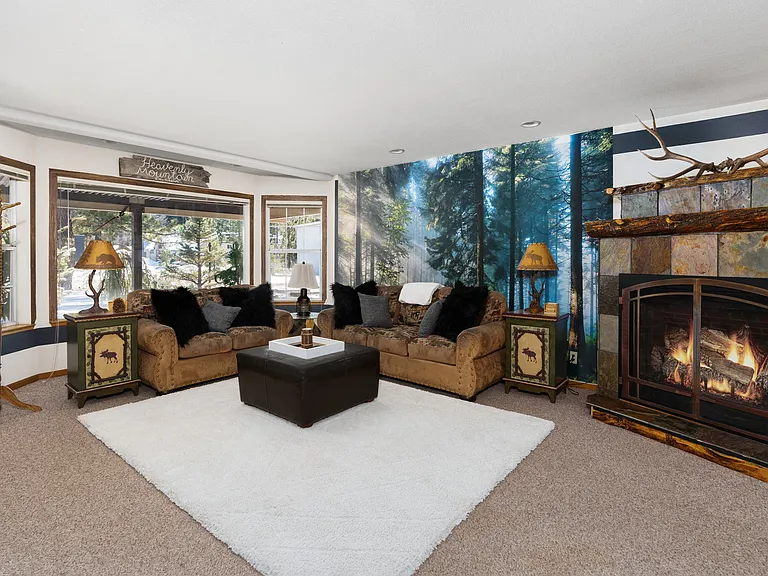 Downstairs main living room with fire, large Smart TV and large windows for BEAUTIFUL Tahoe Mountain views