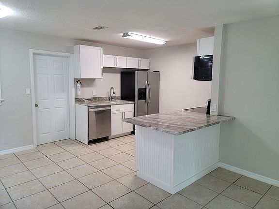 Open plan kitchen with lots of room. New cabinets. Stainless steel appliances. Tile throughout home.