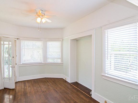 Shared step-out balcony, big double-hung windows all around . . .