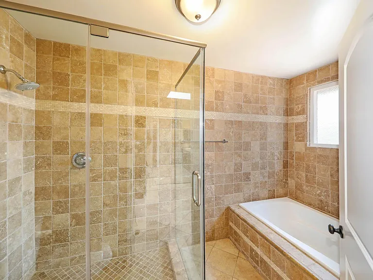 Primary bath stall shower and separate tub.