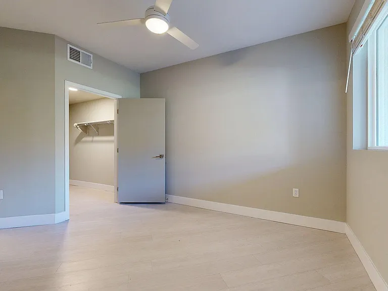 Spacious apartment Bedroom with Wood-Style Flooring.