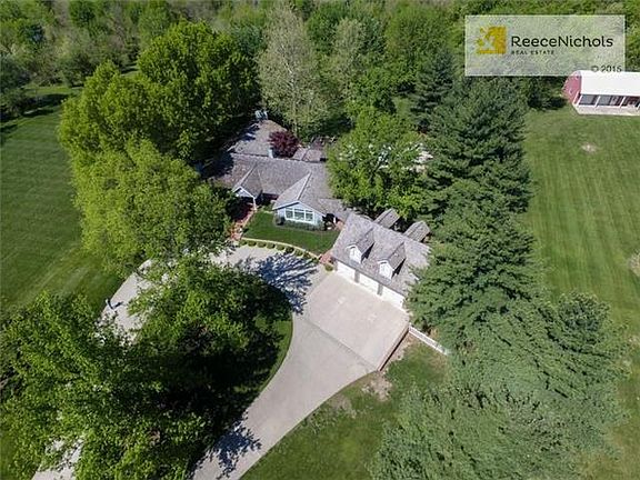 Ariel view of this amazing estate with luscious trees and landscaping.