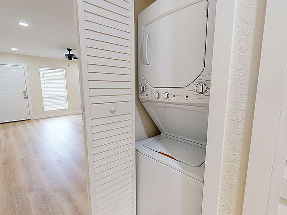 Modern apartment with in-unit washer and dryer, elegant wood flooring, and abundant natural light.