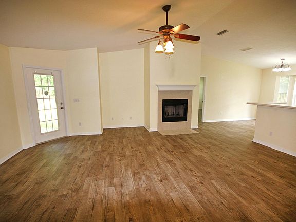 Living room with working gas fireplace - new laminate wood floors