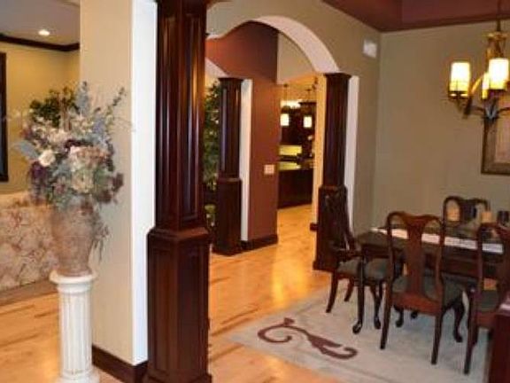 Arched headers separate living spaces but allow the open floor plan to flow seamlessly from room to room.