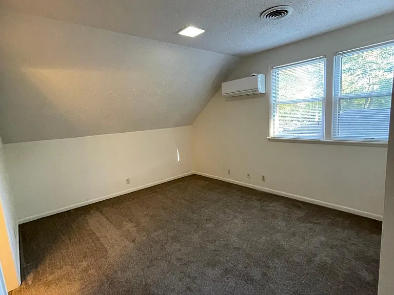 This is one of the 2 upstairs bedrooms that are spacious. We had a mini split unit installed in each of these upstairs bedrooms so that each person could set the temperature to their liking, for both the heat and cooling. The house has central heat and