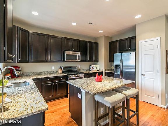 Kitchen with HW, SS appl, and granite counters