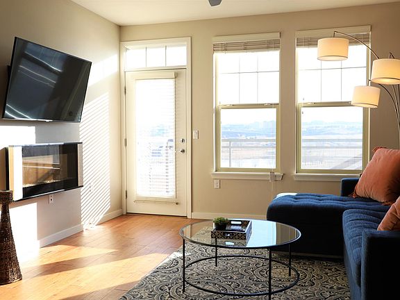 Electric fireplace and balcony off the main living area