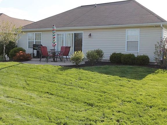 VIEW OF THE BACK OF HOME SHOWING THE NICE PATIO FOR SITTING OUT AND ENJOYING ALL THE PEACE AND QUIET.
