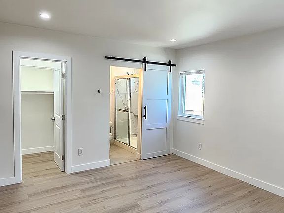 Master bedroom with walk-in closet and bath entry way.