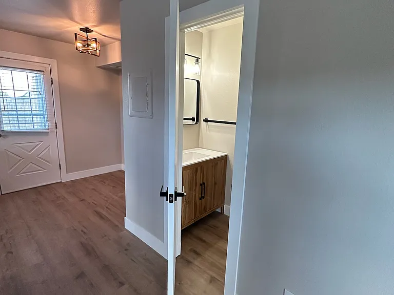 Half bath in hallway going to kitchen.