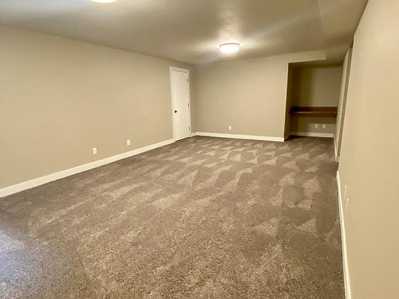 Downstairs living area w/ built-in study nook/desk