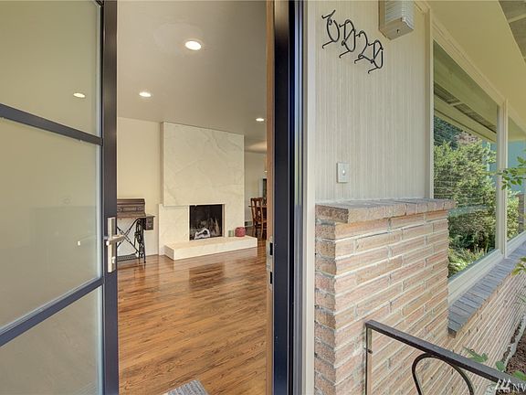 Entry into home, awesome hardwoods, wood wrapped windows, west facing home, recessed lighting and fireplace