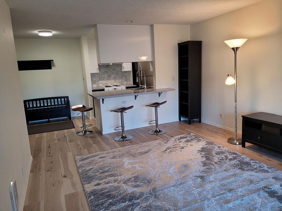 Great Room to Open Kitchen/Counter (w/USB 2 outlets) from Balcony area. New lighting in Kitchen and Counter area. New Carpet over New Pergo Floor.