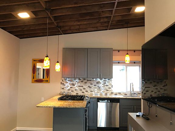 High ceiling with pendant and recessed lighting