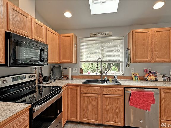 Updated kitchen with newer appliances. Kitchen window looks over backyard. 