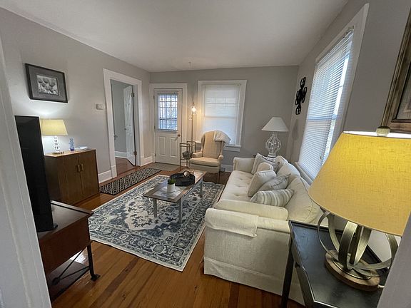 Living room w/ front door and small BR door