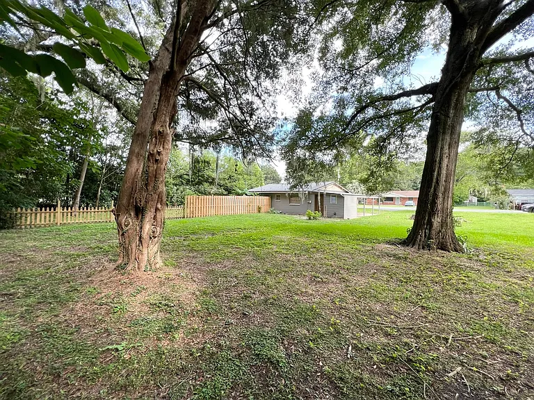 Back and side yard from corner of the lot. A wooden fence divides your backyard from your neighbor in the other half duplex