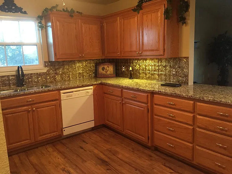 Kitchen showing custom backsplash.