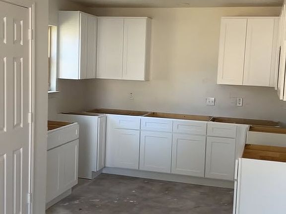 Open-concept living area and kitchen. This is your view from the living room. Ample shaker style cabinets with soon-to-be granite countertops and waterproof flooring.