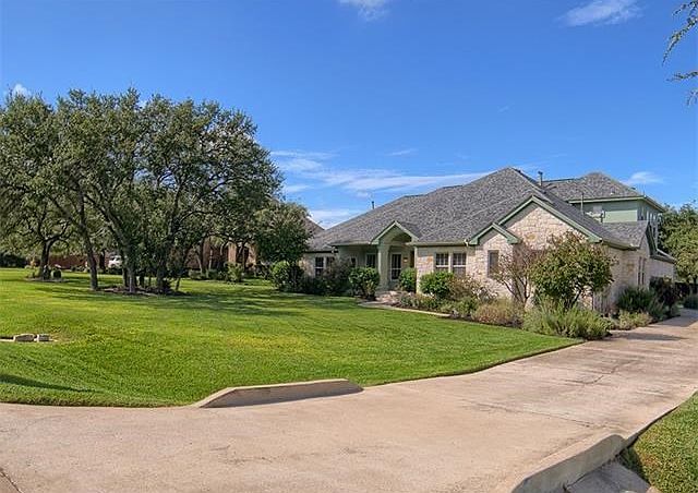 This beautiful property is tucked beneath a canopy of mature oaks and oozes curb appeal!