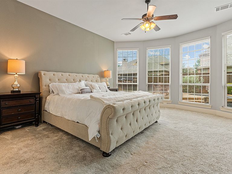 Primary suite with bay windows and a sitting area filled with natural light