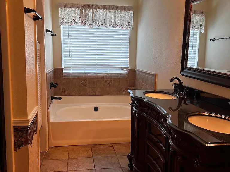 Master bath - Features double sink vanity with granite countertop, garden tub, separate shower.
