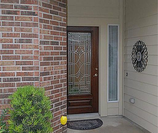 A closer view of the fully leaded front door with a protected entrance