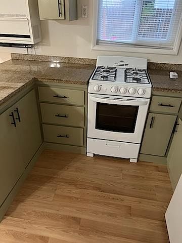 Cozy Kitchen with 24 inch stove and refrigerator, granite counters