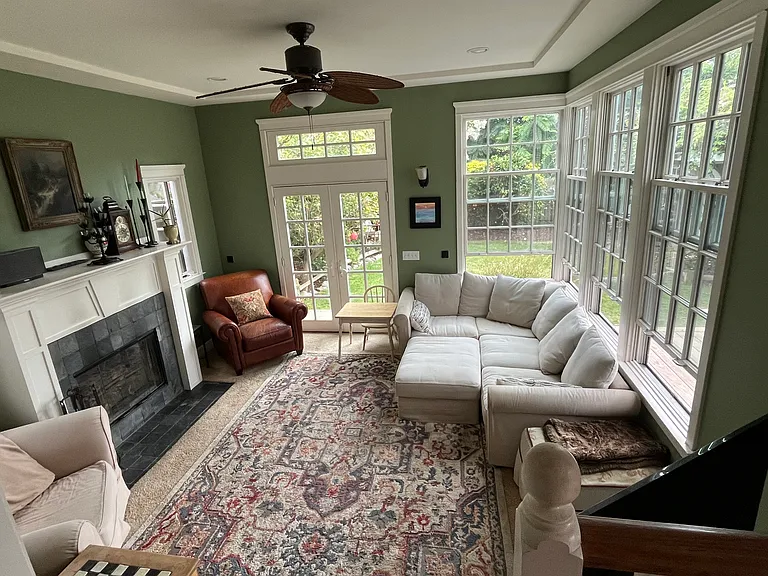 Family room with wood-burning fireplace overlooking our lush garden and deck.