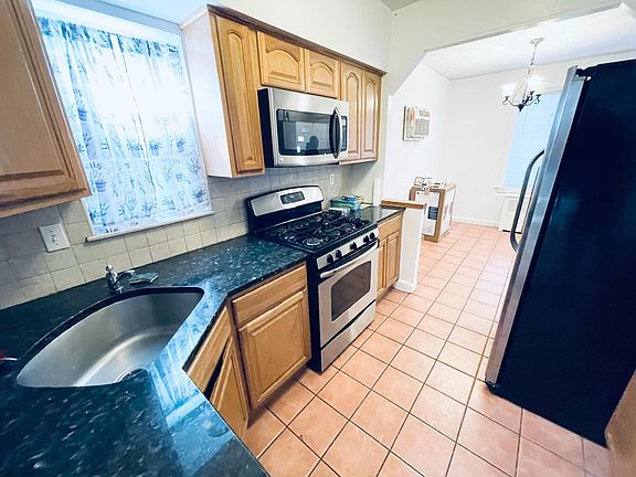 Stainless stove and microwave next to DEEP SINK!
