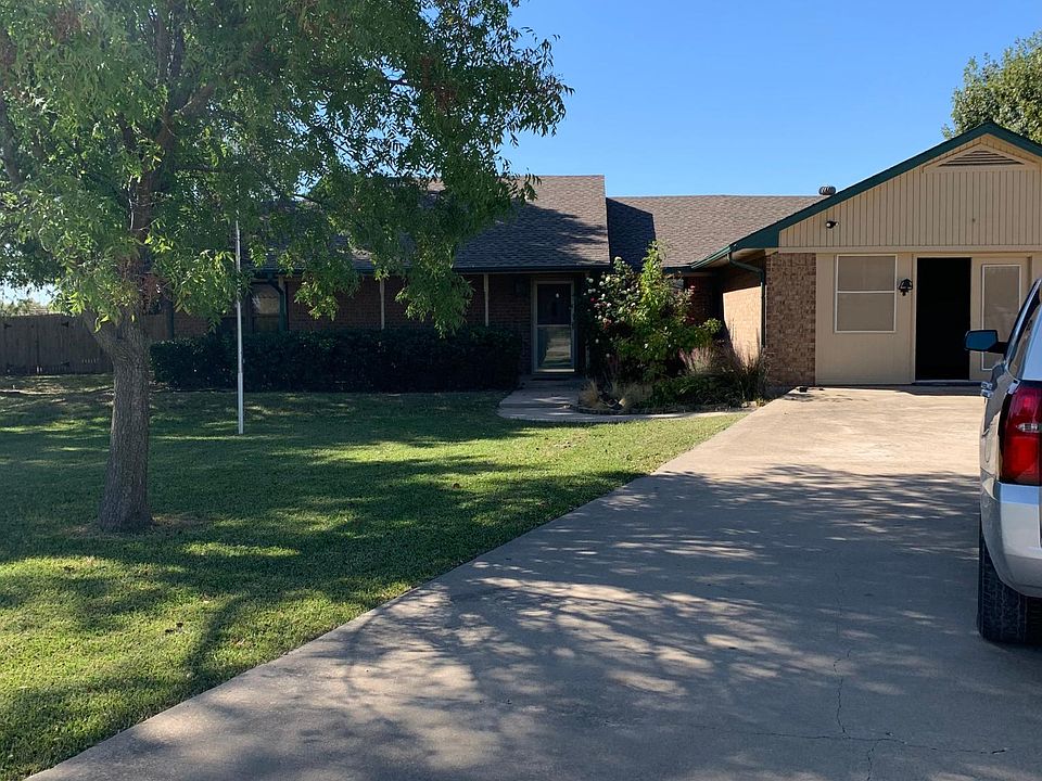 This is a view of the house from the street. To the right is a built on addition that has been used as a gameroom or bedroom.