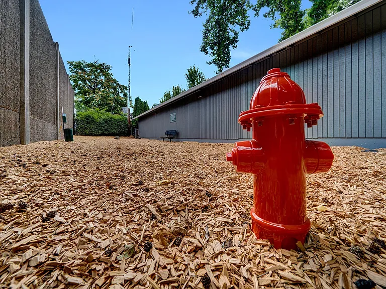 a red fire hydrant in front of a building Sunset Station Apartments Portland Oregon
