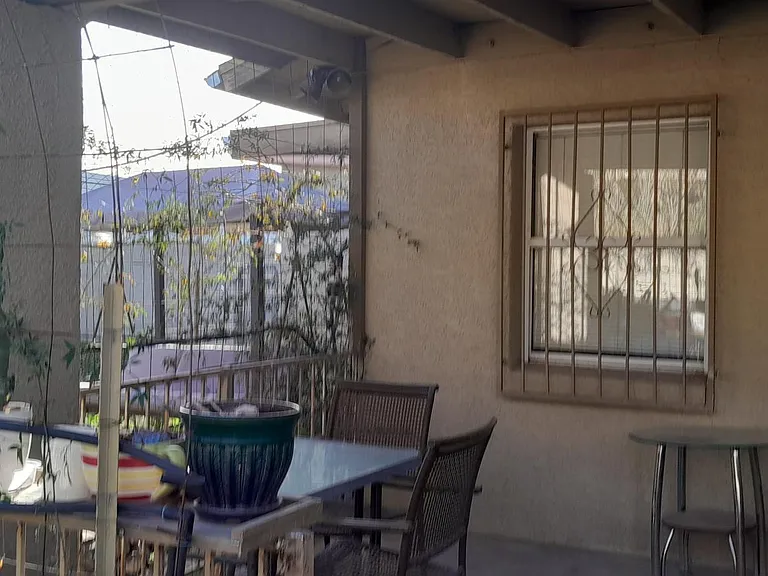 The covered patio with outdoor furniture.