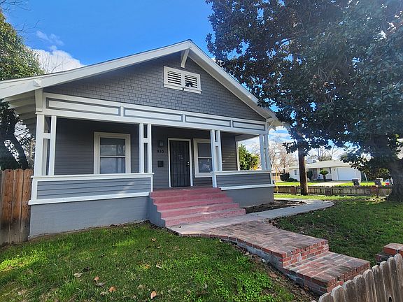 Front of house with large front porch and fenced front yard