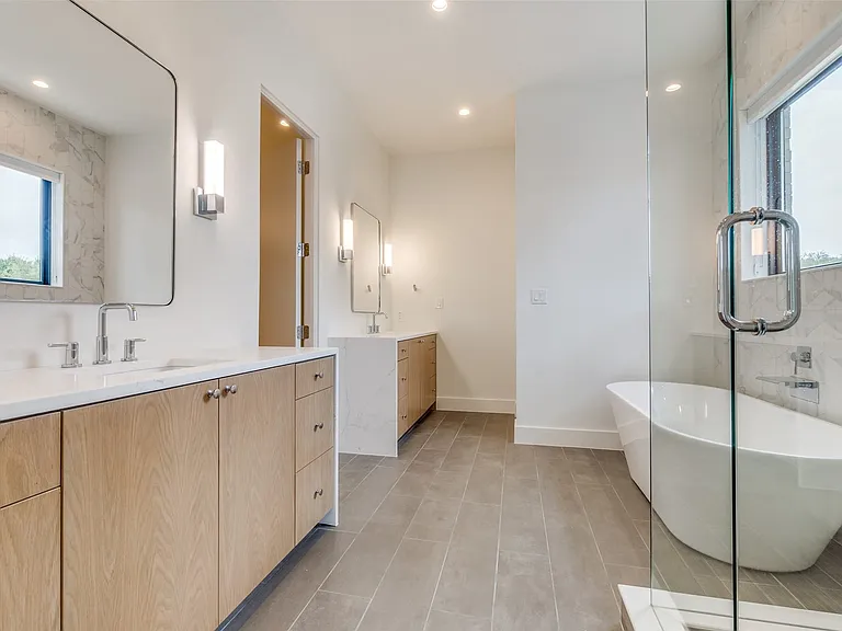 Beauty abounds with waterfall quartz counters, sleek cabinetry and natural light