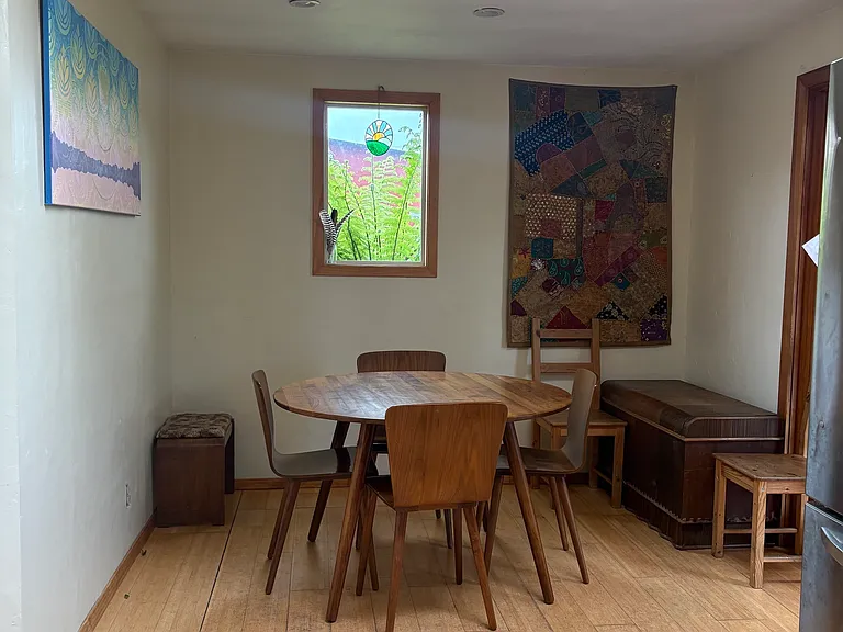 This is the dining area with a small window to the north. It is just off of the kitchen, in an open plan living room/kitchen room/dining area.