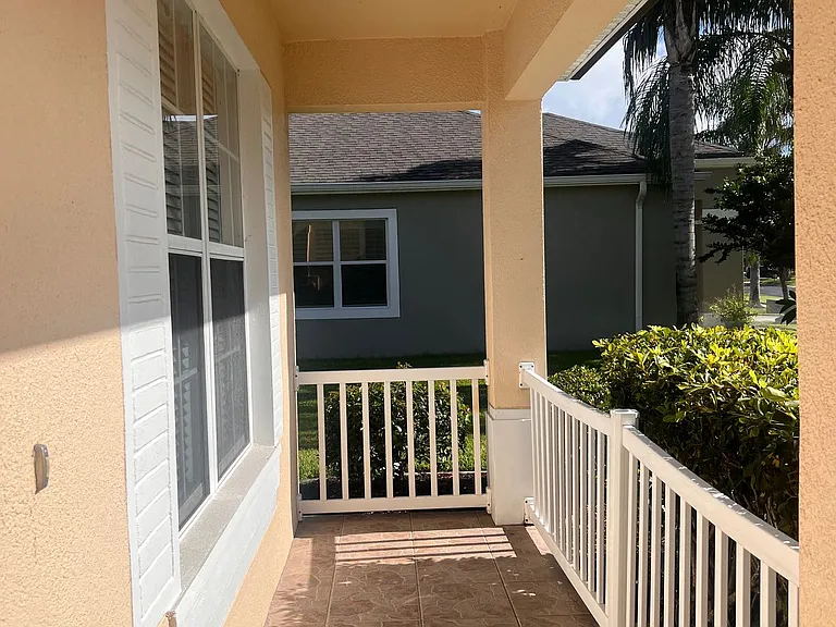 38 - Front porch view with railing and white trim.