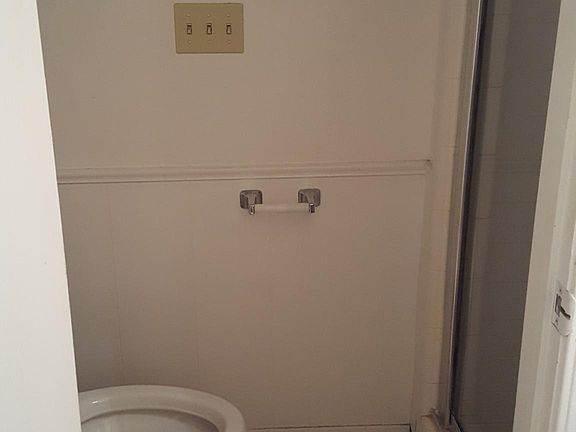 Toilet and shower in master bedroom with door