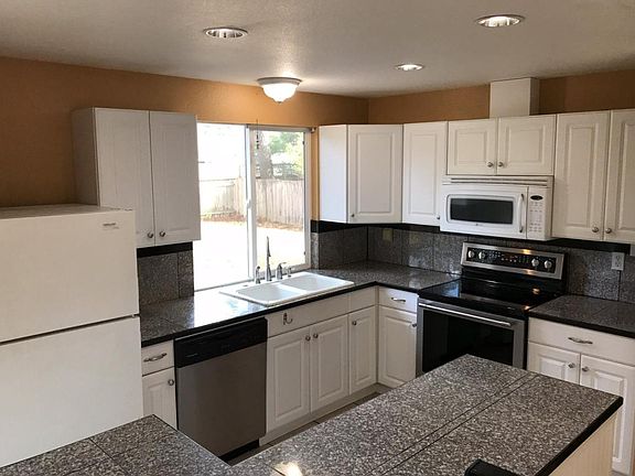 Kitchen with tile floors and granite countertops