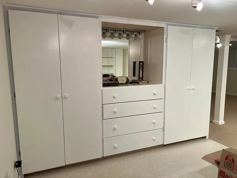 Dresser with mirror, and closets.