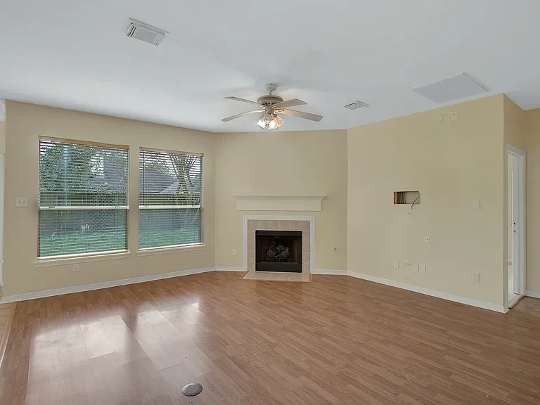 Living with fireplace and view of the large backyard