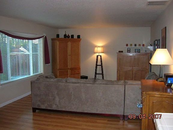 Large living room with large window over looking backyard