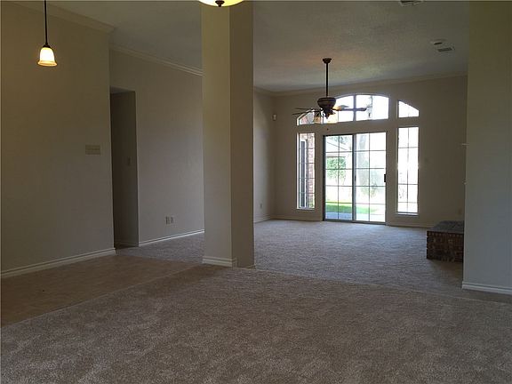 Standing inside the elevated dining room looking into the livving room with fireplace.