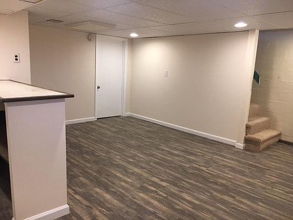 Finished basement with new flooring.