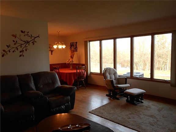 Take note of the large picture window overlooking the fenced-in back yard and the wooded area behind.